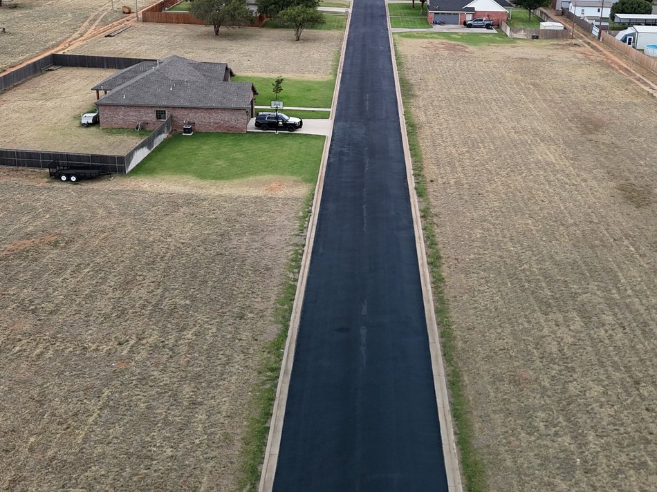 Aerial view of a completed asphalt street built by Bermea Construction