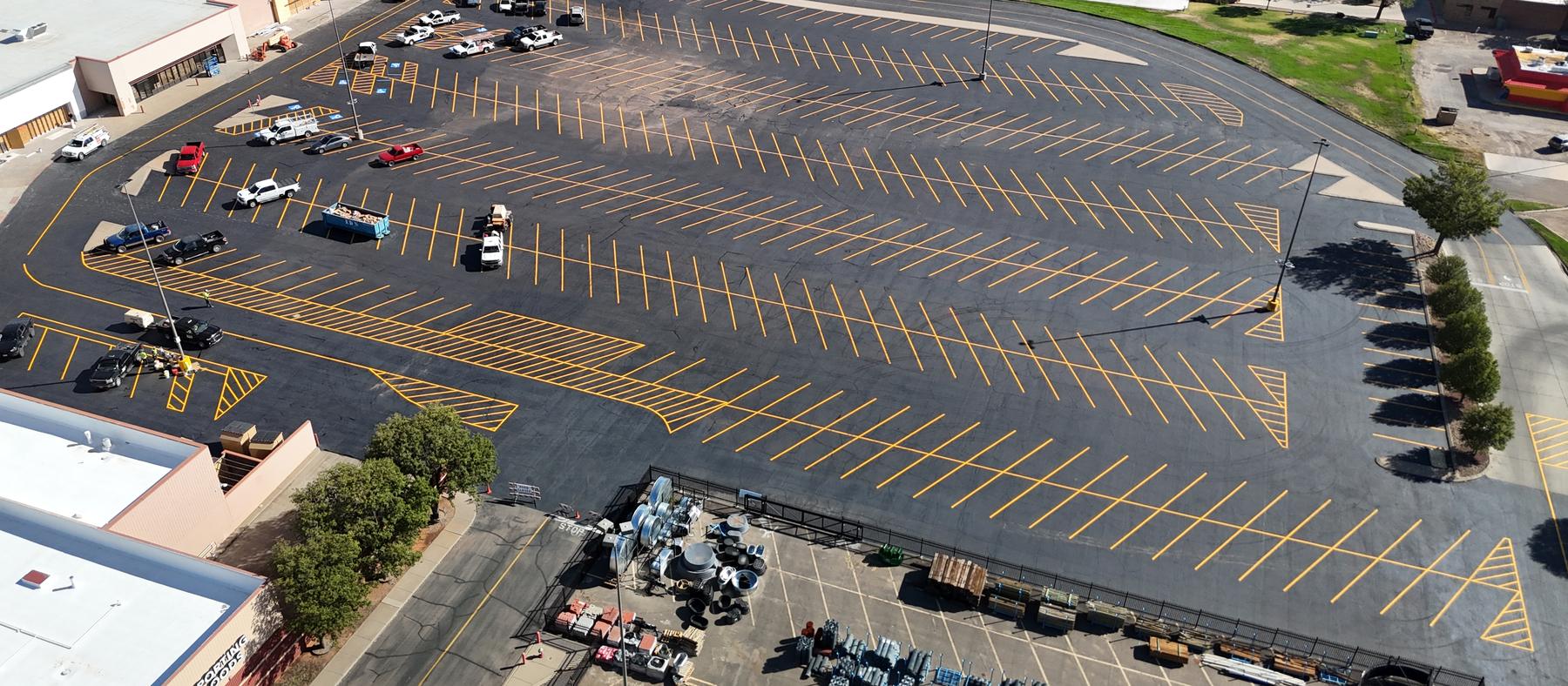 Aerial view of a completed parking lot paved and striped by Bermea Construction