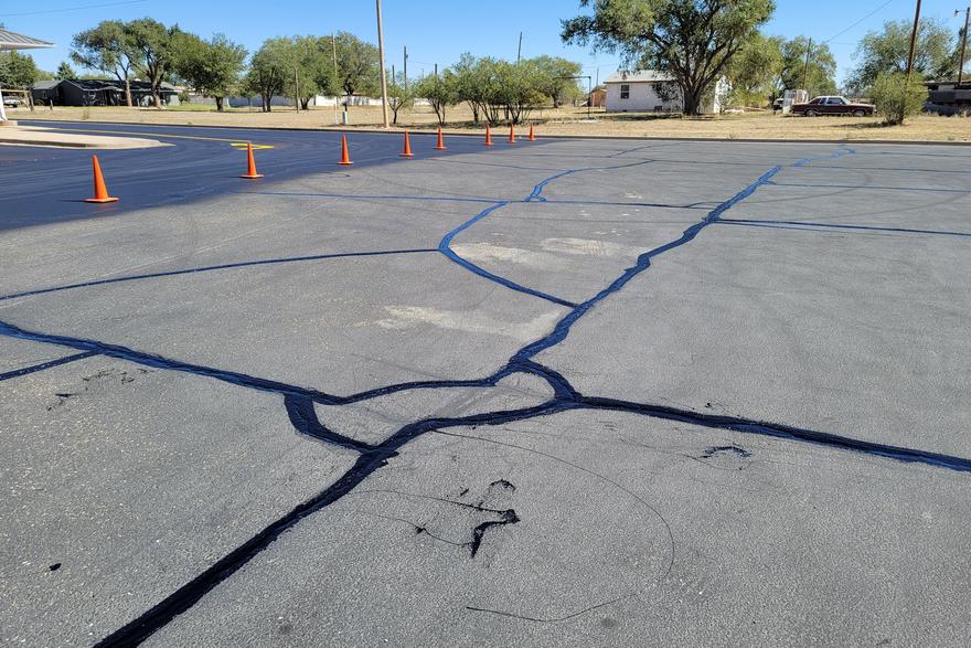 Hot pour crack sealing in progress on a parking lot