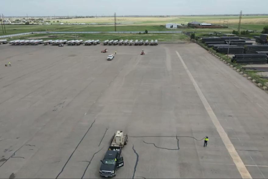 Aerial view of a roller compacting fresh asphalt