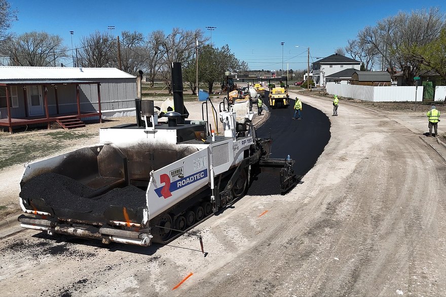 Bermea paver laying a new asphalt mat on a residential street